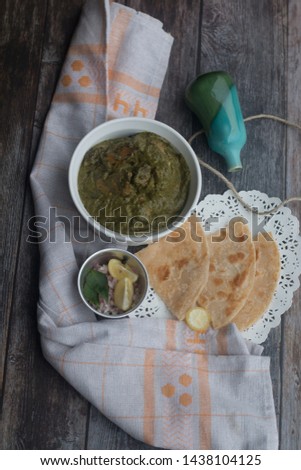 Stock Photo of Saag Chicken it contains Chicken, cooked in Palak gravy (Spinach) with Indian spices. Served with roti (flat Indian bread)
