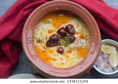 Stock photo fo Punjabi Kadhi Pakoda or curry Pakora, Indian cuisine served in a bowl or karahi served in traditional clay pot called handi 