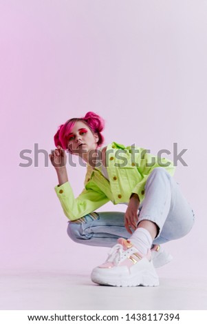 woman in green jacket sitting on the floor
