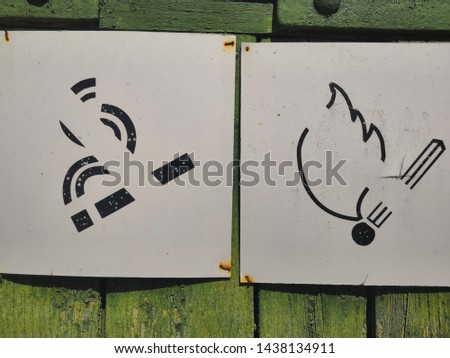 vintage brick wall and no Smoking signs