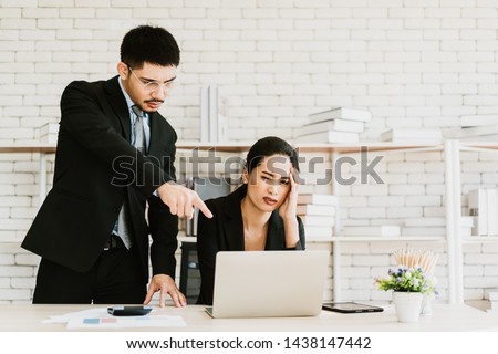 Boss giving order or firing employee. Powerful business man pointing laptop with finger.Angry executive or manager. Tough leadership, strict discipline, workplace bullying or fight at work. Royalty-Free Stock Photo #1438147442