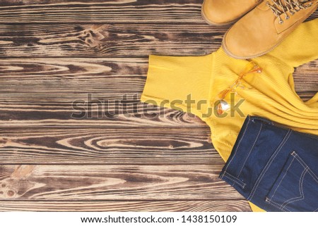 Top view shot of autumn background. Fall woman`s clothes flat lay picture. Woman wardrobe.