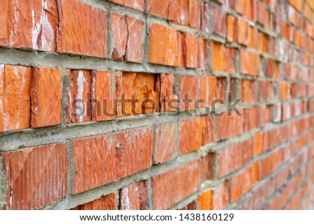 Old cracked red bricks in the brick wall, receding into distance