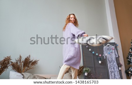 Dancing girl in sleepwear looking to camera. Smiling female model in shorts posing in bedroom.