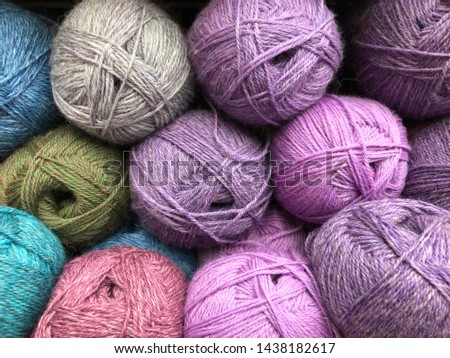 multicolored threads for knitting on the shelf