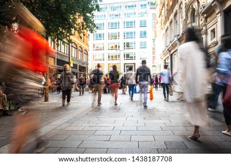 Motion blurred crowds of shoppers on busy London street Royalty-Free Stock Photo #1438187708