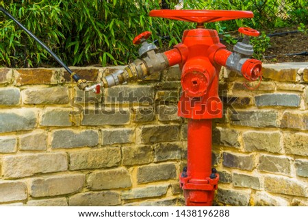 red fire hydrant with multiple hose fittings, fire prevention system, outdoor safety