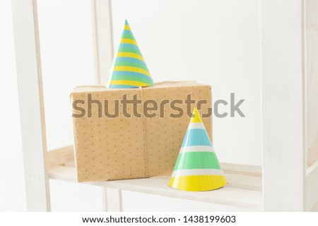 Striped colourful cones hats and gift box. Birthday holiday party concept.