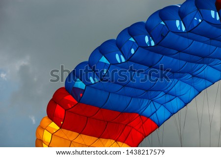 Details of bright multi-colored parachute canopy, close-up. Royalty-Free Stock Photo #1438217579