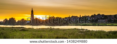 Skyline of the city of Rhenen during sunset with Cunera church and river Nederrrijn in the provence of Utrecht in the Netherlands