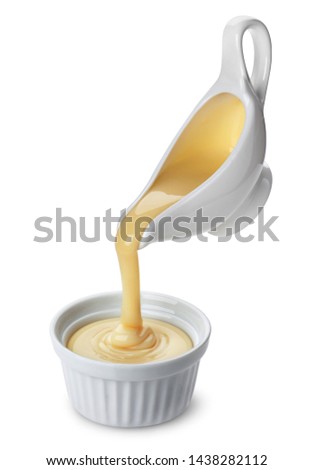 Pouring condensed milk isolated on white background with clipping path Royalty-Free Stock Photo #1438282112