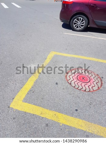 Abstract image. The beauty of car parking. The contrast of yellow square contour and red circles. Red car.