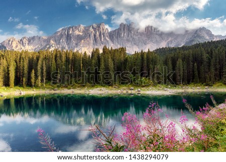 Incredible nature landscape.Sunny autumn day in Dolomites Alps. Lake Carezza with Mount Latemar, Bolzano province, South tyrol, Italy. popular travel locations. Picture of wild area 