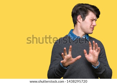Young handsome elegant man over isolated background disgusted expression, displeased and fearful doing disgust face because aversion reaction. With hands raised. Annoying concept. Royalty-Free Stock Photo #1438295720
