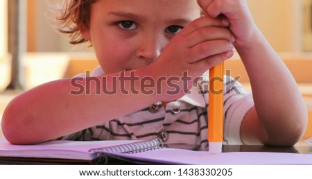 Portrait of little boy holding color pen