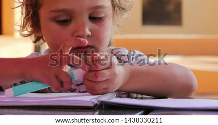 Portrait of little boy holding color pen