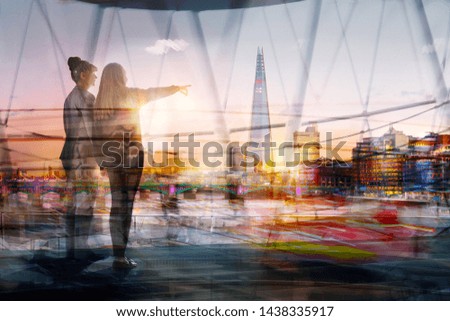 Two woman, younger and elder looking over the  City of London at sunset. Future, new opportunity, freedom and travelling concept. Two generations. London, UK