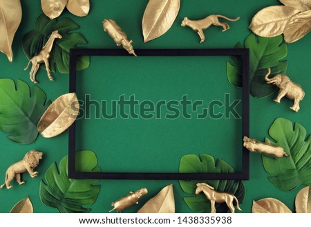 Abstract green background with golden tropical leaves and exotic animals