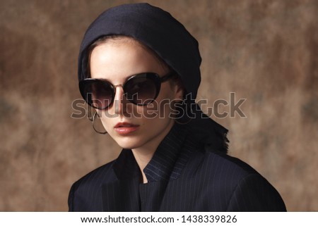 young stylish muslim woman on beige textured background, close up portrait Royalty-Free Stock Photo #1438339826