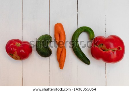 Ugly vegetables on white wooden table. Horizontal orientation, top view Royalty-Free Stock Photo #1438355054