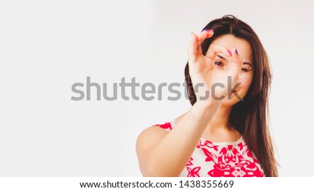 Woman making a perfect gesture with her fingers as if she wants to say: everything will be Okay. Selective focus on eye.