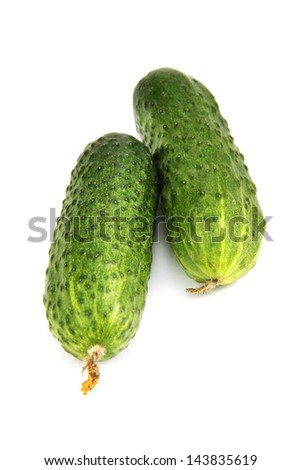 few green cucumbers close-up photo on the white background.