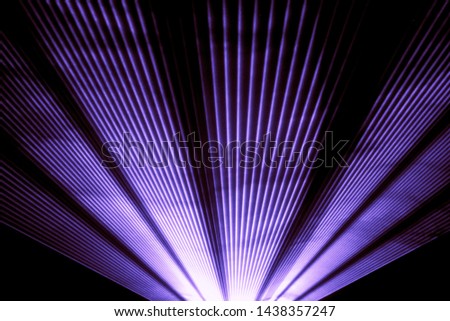 Purple laser show nightlife club stage shining sparkling rays. Luxury entertainment in nightclub event, festival, concert or New Years Eve. Ray beams are symbol for science and universe research