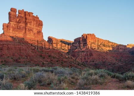 Low angle landscape of tall monoliths or buttes against the sky at dawn at Valley of the Gods in Bears Ears National Monument in Utah