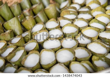 Steamed coconut milk in banana leaf cone Royalty-Free Stock Photo #1438474043