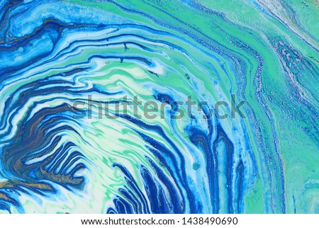 photography of abstract marbleized effect background. Blue, mint, gold and white creative colors. Beautiful paint.