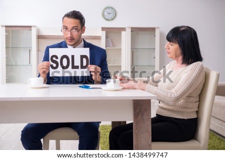 Male real estate agent and female client in the apartment 