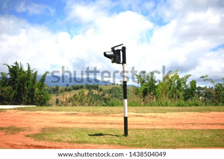 Traffic lights in a blue background and mountain landscape