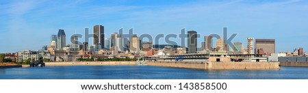 Montreal city skyline panorama over river in the day with urban buildings