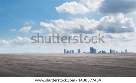 Abstract asphalt and city skyline backdrop