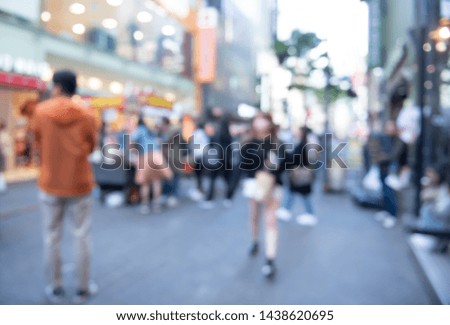 Abstract blurred asian crowd people, tourist group walking and shopping on street market and light bokeh in summer holiday can be used for business background, Seoul, Korea, perspective view