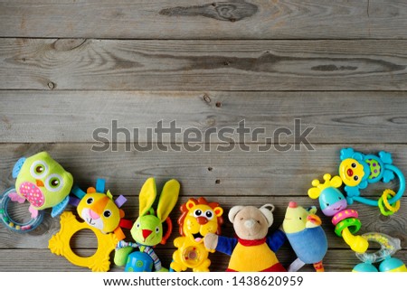 Set of toys for newborn on wooden background. top view