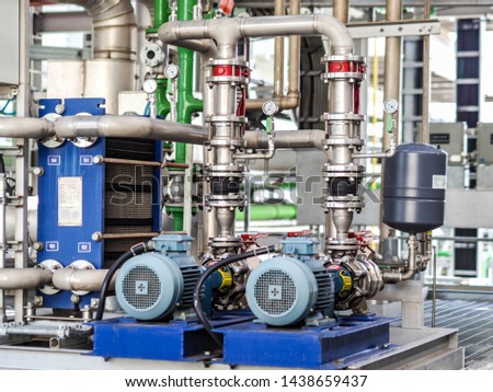 Pump and motor which popular to install with pipe in industrial such chemical, power plant, oil and gas. Royalty-Free Stock Photo #1438659437