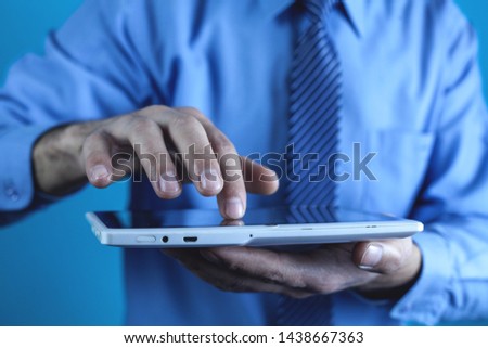 Man using white digital tablet. Technology