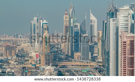 Skyscrapers on Sheikh Zayed Road and DIFC aerial timelapse in Dubai, UAE. Traffic on a highway near Financial Centre at evening before sunset
