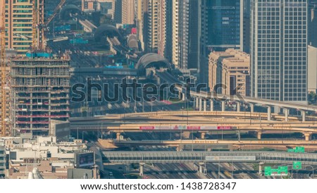 Skyscrapers on Sheikh Zayed Road and DIFC aerial timelapse in Dubai, UAE. Traffic on a highway and intersection near Financial Centre at evening before sunset