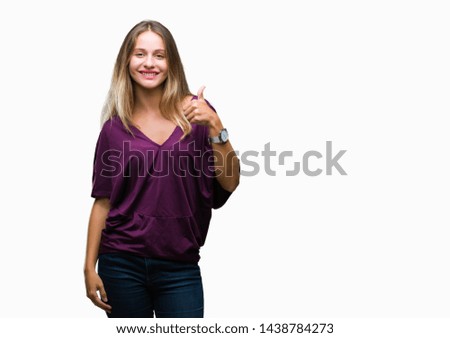 Young beautiful blonde elegant woman over isolated background doing happy thumbs up gesture with hand. Approving expression looking at the camera with showing success.