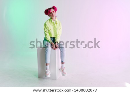 woman in a green jacket with pink hair style