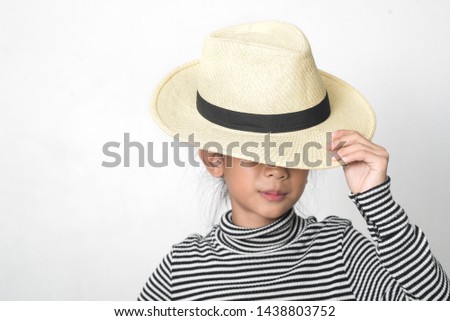 Happy Asian girl waering turtle neck and straw hat on white background.