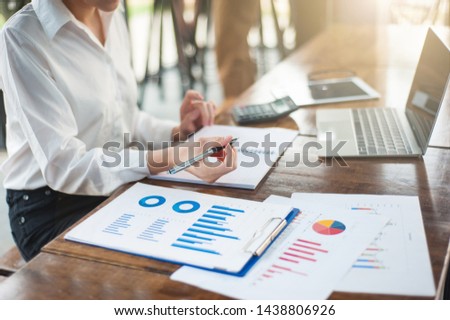 Female businessmen are analyzing marketing and business profits. Businessmen analyze market share and business competitors. Royalty-Free Stock Photo #1438806926