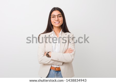 Young business arab woman isolated against a white background who feels confident, crossing arms with determination. Royalty-Free Stock Photo #1438834943
