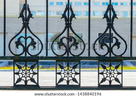 Part of a decorative metal fence.  Front view.