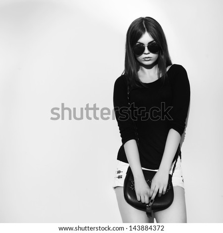  fashion portrait of a young dark hair girl in black and white