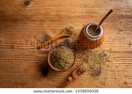 Traditional South American yerba mate leaves and tea served in the calabash with bombilla