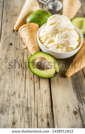 Vegetable gelato. Vegan avocado ice cream, old rustic wooden background. 