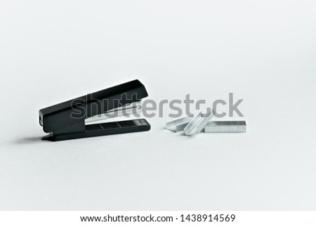 Stapler black with paper clips isolated on white background. Office accessories